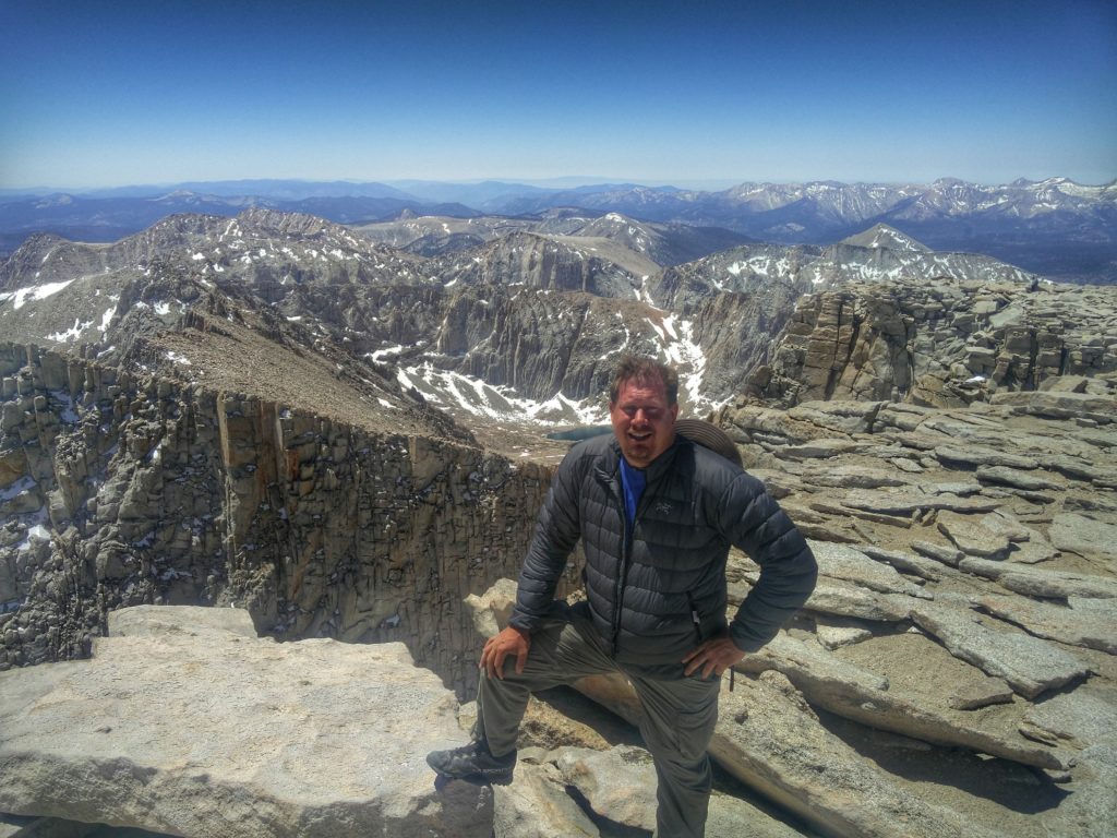 Greg Berndt from Flip Flop Wanderer standing on top of Mt. Whitney. This image is on his About Page.